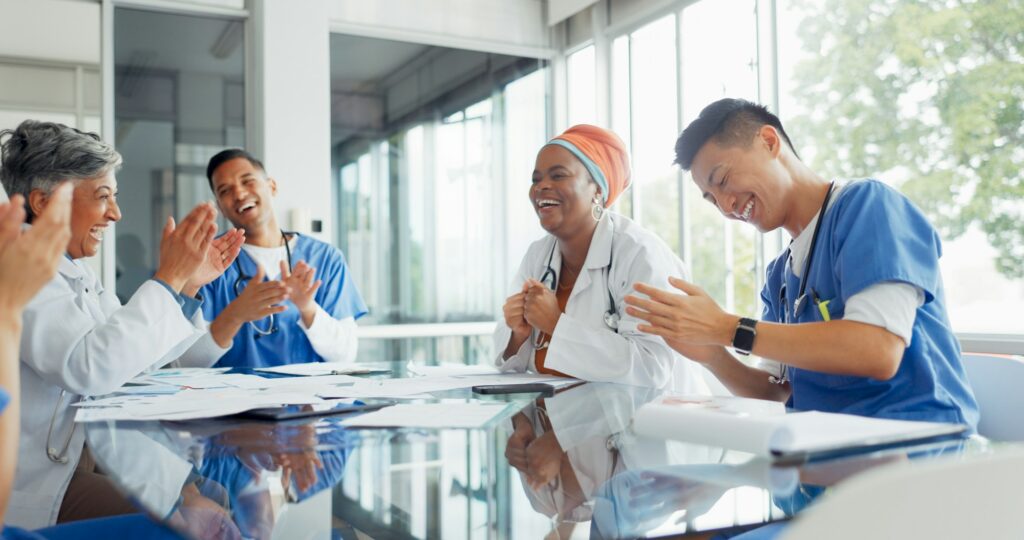 Doctors, nurses and meeting with documents in hospital discussing medical records. Teamwork, planni